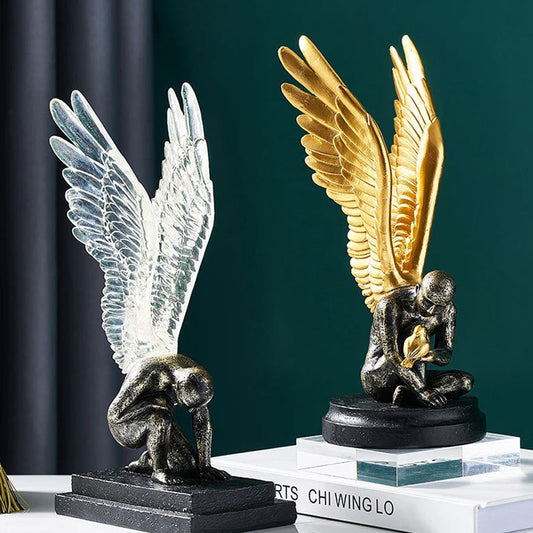 Angel sculpture with golden and silver wings.